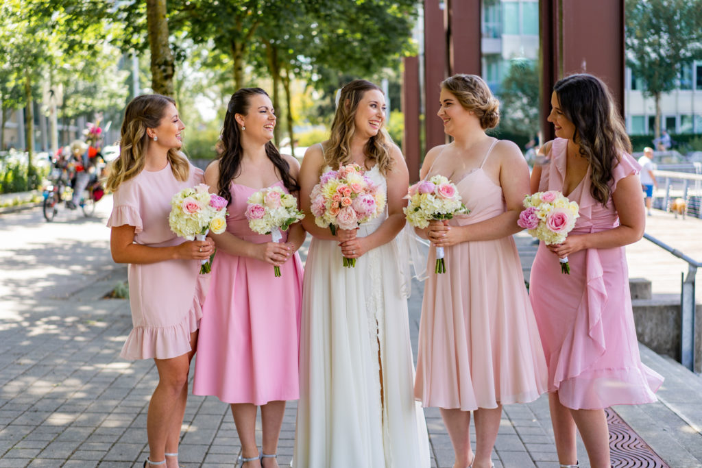 Bride and her bridesmaids in light pink dress at Olympic Village