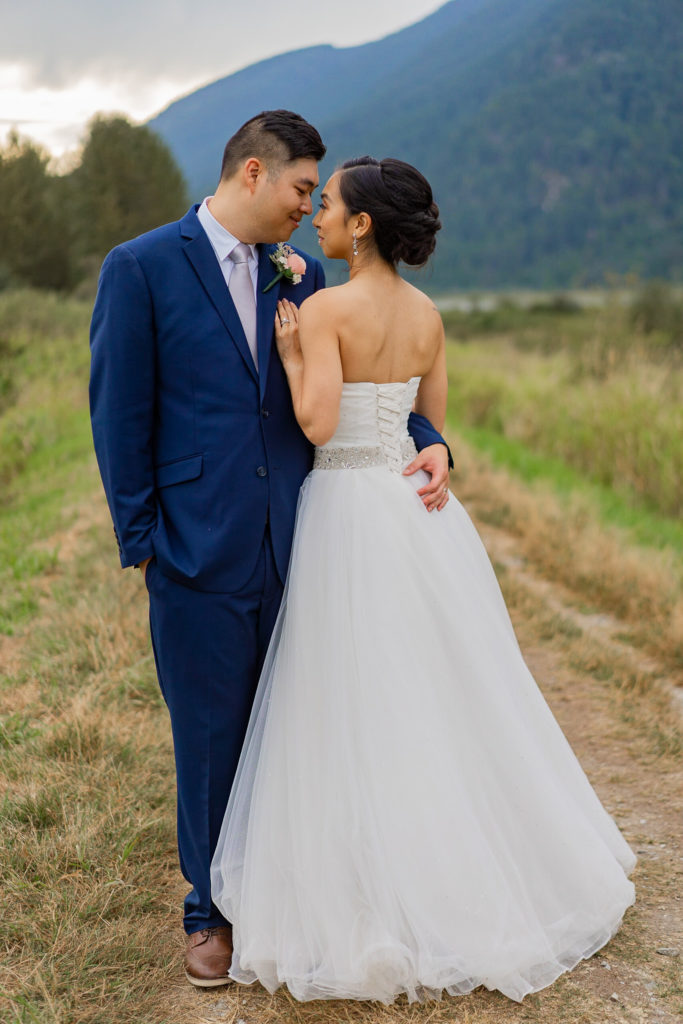 Intimate moment between groom and bride at Pitt Lake