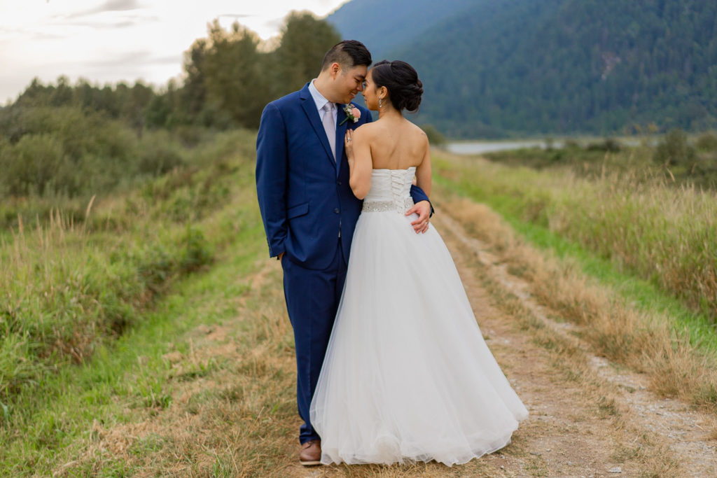 just married groom and bride sharing an intimate moment out at Pitt Lake
