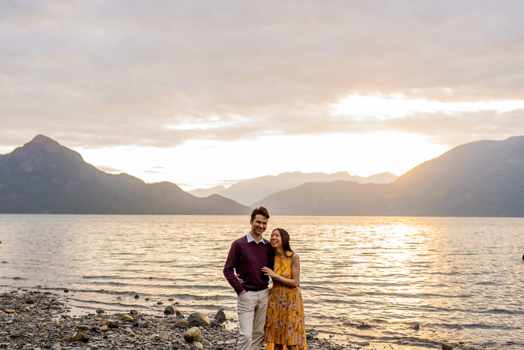 couple laughing during sunset at Porteau Cove along the beach