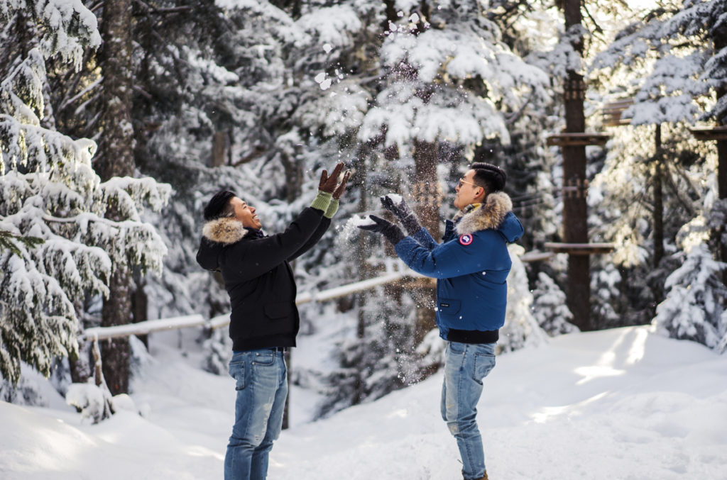Gay couple throwing snow at Grouse Mountain
