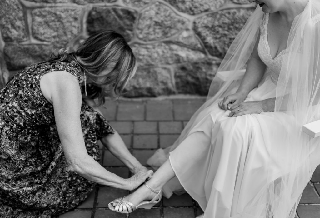 mom helping bride during getting ready