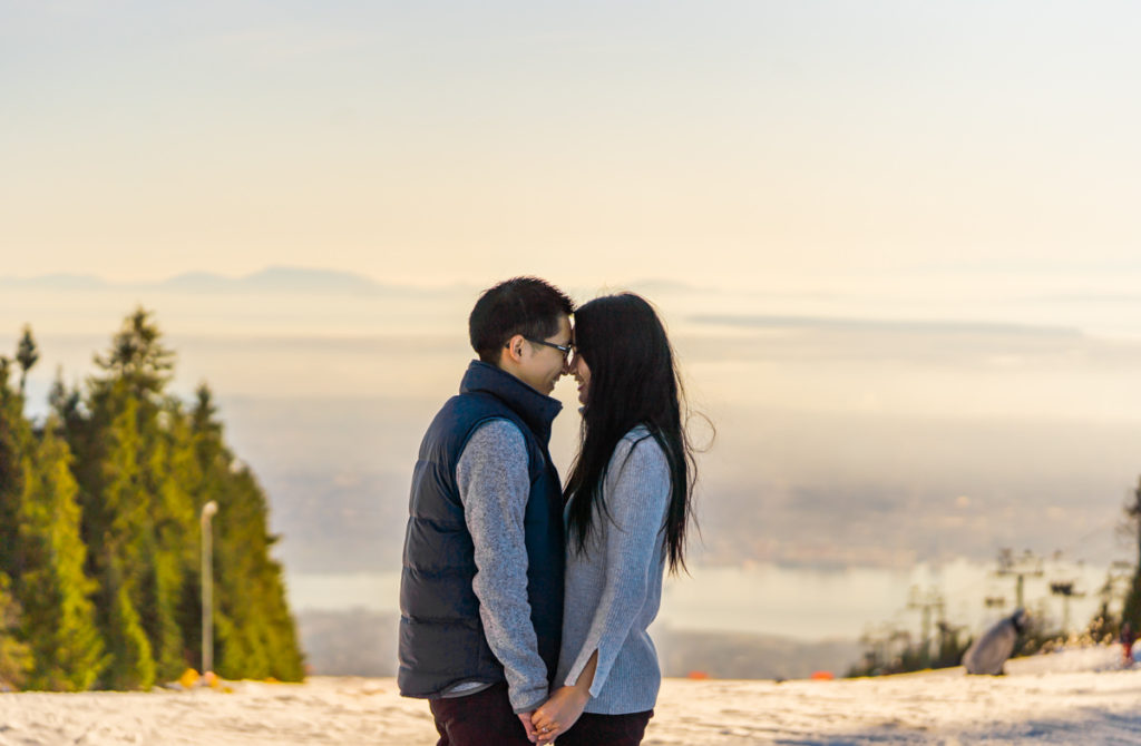 couple holdings hands on the top of Grouse Mountain