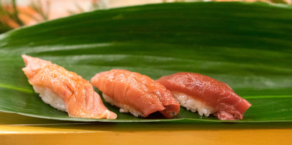 Three pieces of tuna ( from right to left): tuna nigiri, medium fatty, fatty