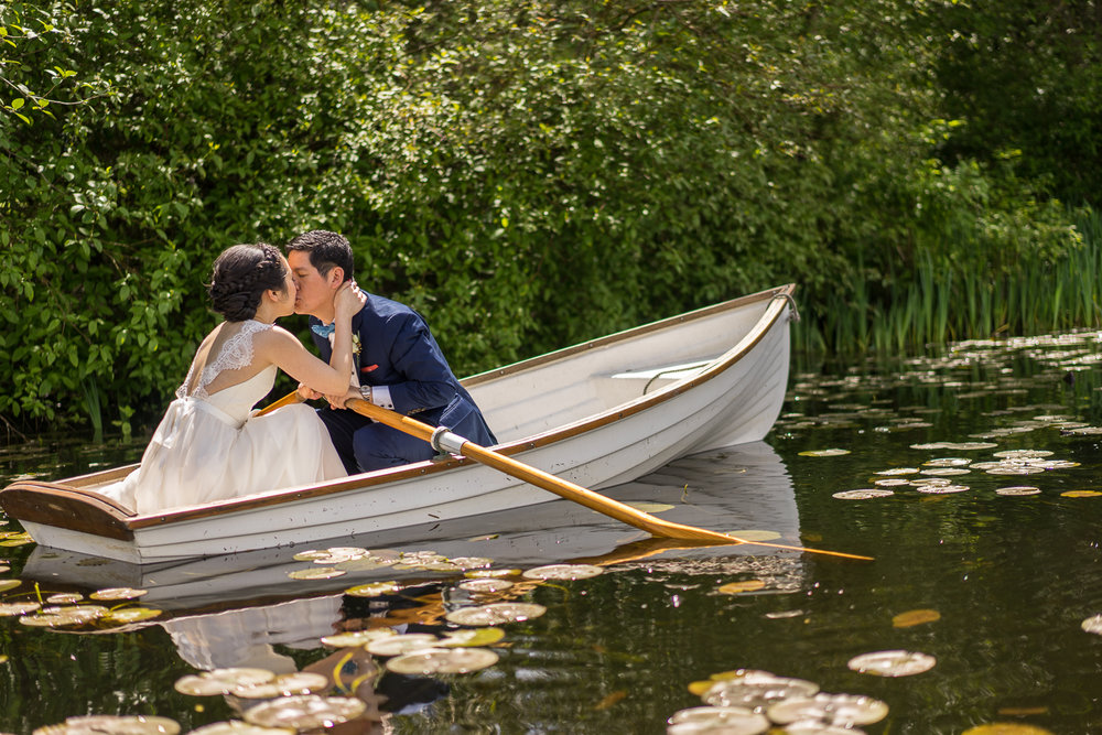 Bride and groom at deer lake in boat 