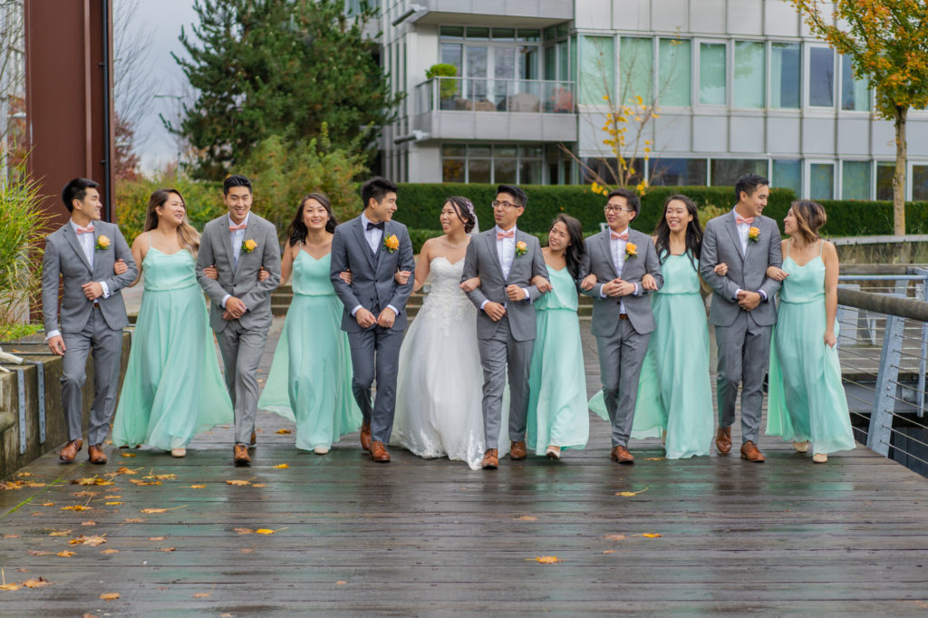 Photos of bridal party walking in the rain at Olympic Village