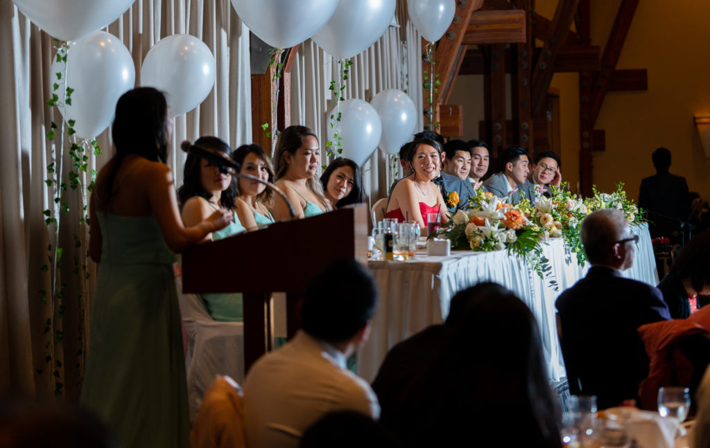 Bride listening to her bridesmaid giving a speech at Coquitlam wedding venue