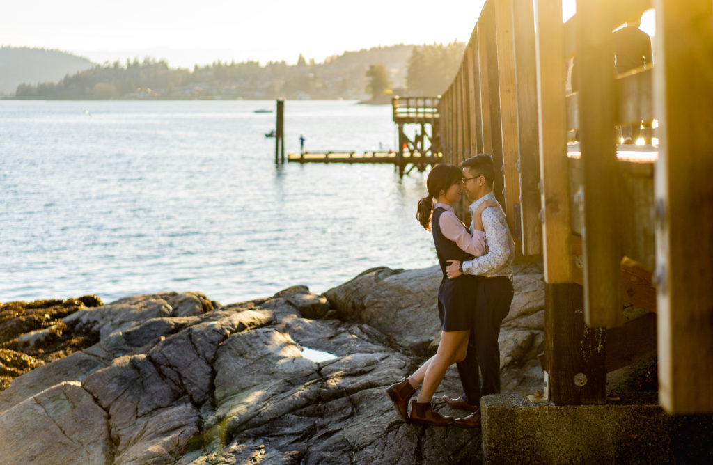 Couple by the pier at Belcarra Park for their engagement photos