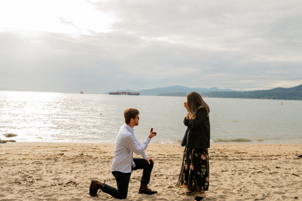 guy proposing on one knee with a mountain backdrop
