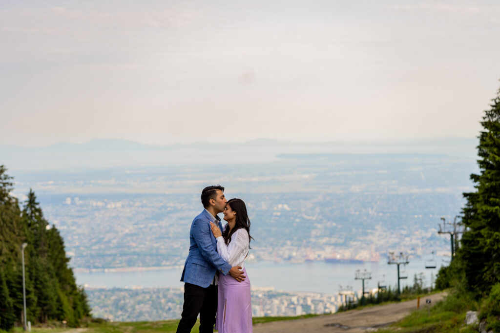 couple hugging on the top of Grouse Mountain