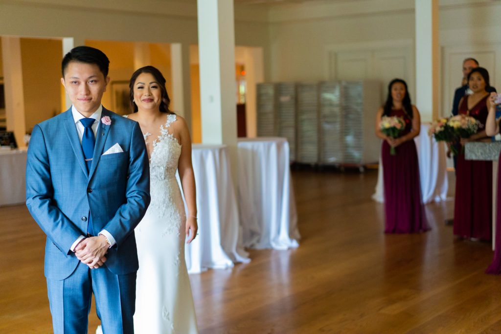 Bride walks towards his groom for the first look at Stanley Park Pavilion