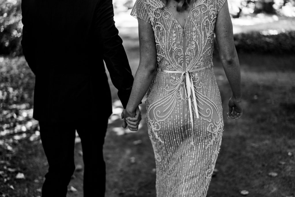 bride and groom walking through Stanley Park