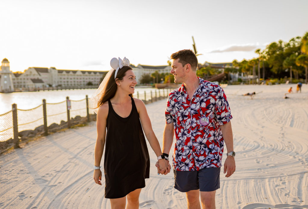 couple walking along on the sand at Disney World Boardwalk